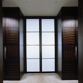 A wardrobe made of tropical wood with double glass door
