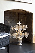 Silver candle stand on a hearth