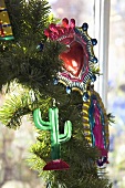 Metal Christmas decorations on a branch of a Christmas tree