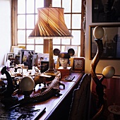 A table lamp on a desk and stuff reptiles in a South African country house