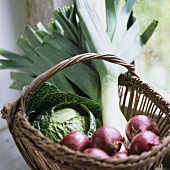Onions, cabbage and leek in a basket