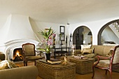 A sofa and wicker tables in Mediterranean living room with arched doorways