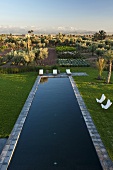 Moroccan landscape - view over a garden pool and an agricultural area