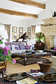 A coffee table and a sofa in a Mediterranean living room with a wood beam ceiling
