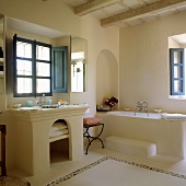 A stone, Spanish-style bathroom with blue window and inside shutters
