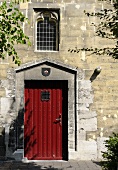 A red door in a stone facade of a church