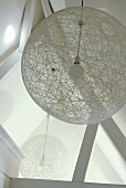 A view of a round designer ceiling lamp made of meshwork