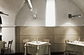 Restaurant tables in an arched niche with decorative lighting