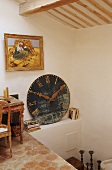 An attic in a country house - a pedestal and a shelf with an antique clock face