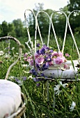 A white garden chair in a meadow