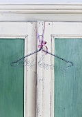 Coat hanger hanging on a wardrobe door