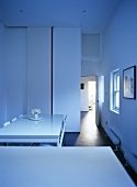 Minimalist kitchen in white with polished floor boards