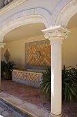 Decorative column of veranda with tiled floor and bath