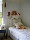 Cushions on single bed in blue bedroom