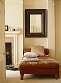 View through open door to leather daybed next to fireplace