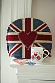 Cushion with Union Jack motif on upholstered armchair