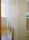 A detail of a partition wall separating a kitchen from another room, wooden floor,