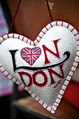 A hanging heart-shaped cushion with the Union flag