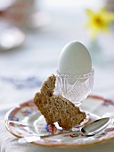 An egg in an egg cup and a piece of rabbit-shaped toast