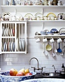 A country-style wall board with crockery and a plate dryer