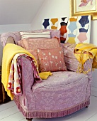Lilac lounge chair with cushions and clothing
