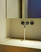 A designer stone wash basin with wall taps