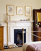 Shoes in front of a fireplace with white wood panelling