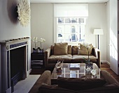 A modern, light brown sofa in front of a fireplace