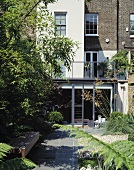 An English house with a modern extension and a garden