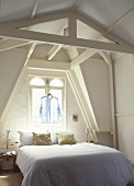 An attic bedroom with a double bed