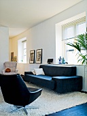 A living room with black and white seats