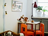 A table and small chairs in a child's room