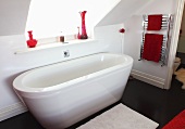 A free-standing bathtub below a skylight