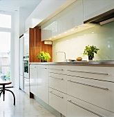 A kitchen with white cupboards