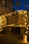A terrace illuminated with fairy lights in the evening