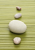 Four stones on bast mat