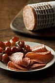 Salami, partly sliced, with grapes