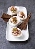 Eggs stuffed with shrimps and dill, pumpernickel