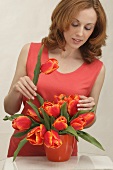 A woman with a bunch of red tulips
