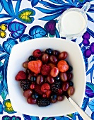 Fresh berries and grapes with cream