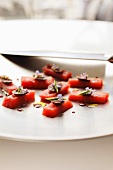 Tuna canapes with chocolate, rosemary flowers, olive oil and balsamic vinegar