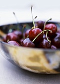 A metal bowl of cherries