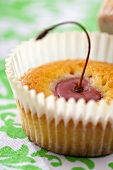 A cherry muffin with a whole cherry (close-up)