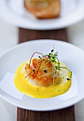 Scallops in saffron sauce with sprouts