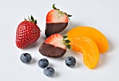 Chocolate strawberries, blueberries and peach slices