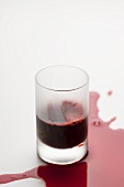 Red juice (apertif) in a glass, spilled