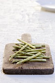 Green asparagus on an old cutting board