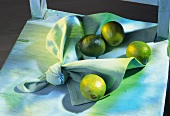 Four limes on a napkin