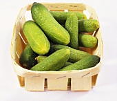 Pickled gherkins in a wooden basket