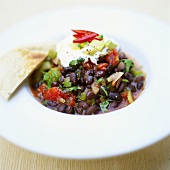 Bean stew with avocado and sour cream